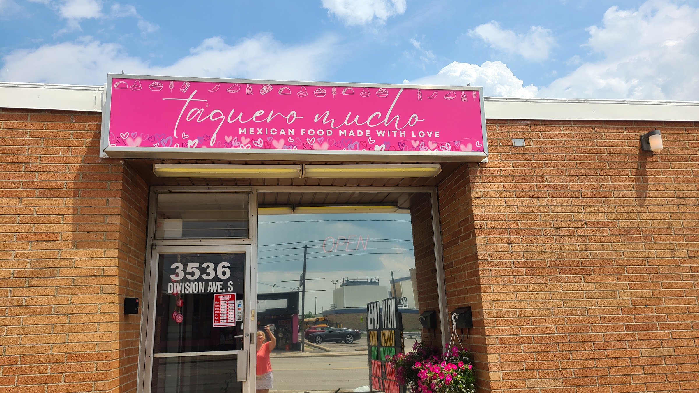 The hot-pink 'taquero mucho — Mexican food made with love' storefront sign